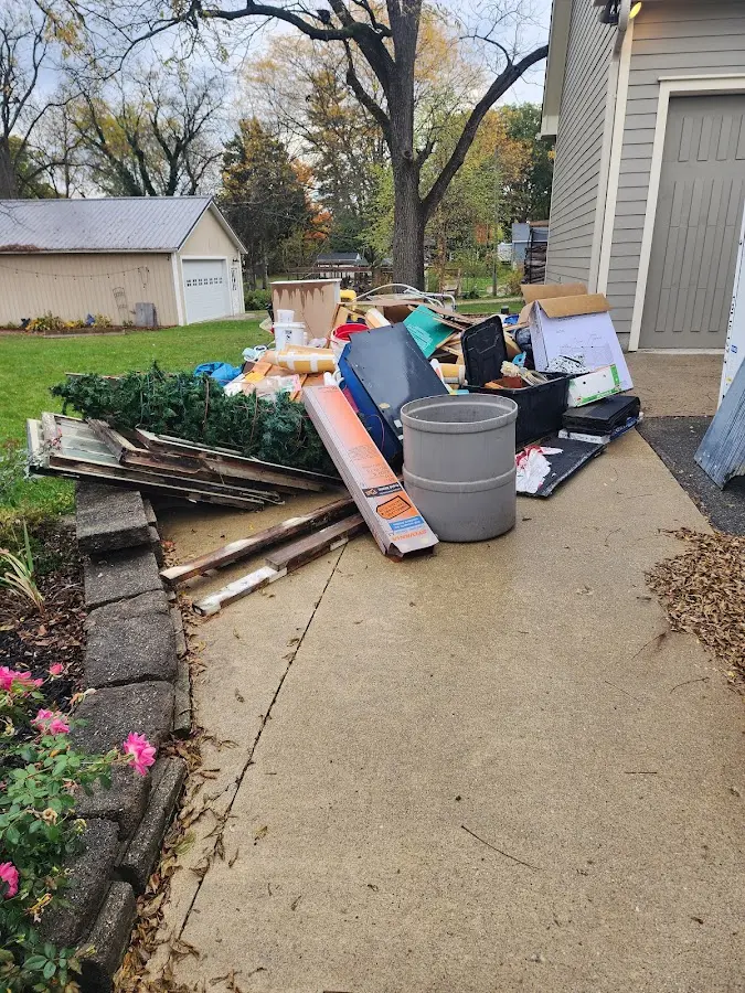 Dumpster being loaded with debris for Estate Cleanout Dumpster Rental in Ringwood